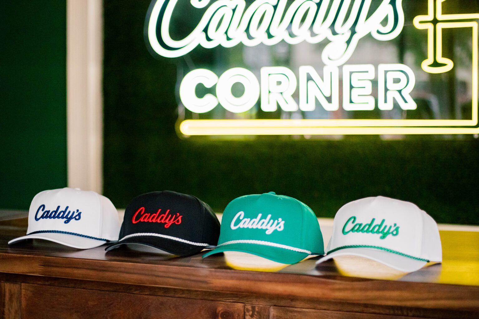 Four colorful Caddys baseball caps displayed side by side.